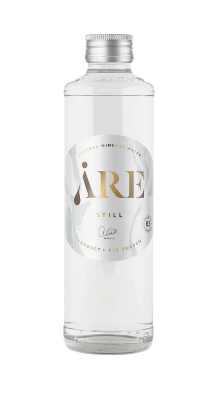 Glass bottle container filled with natural mineral water.